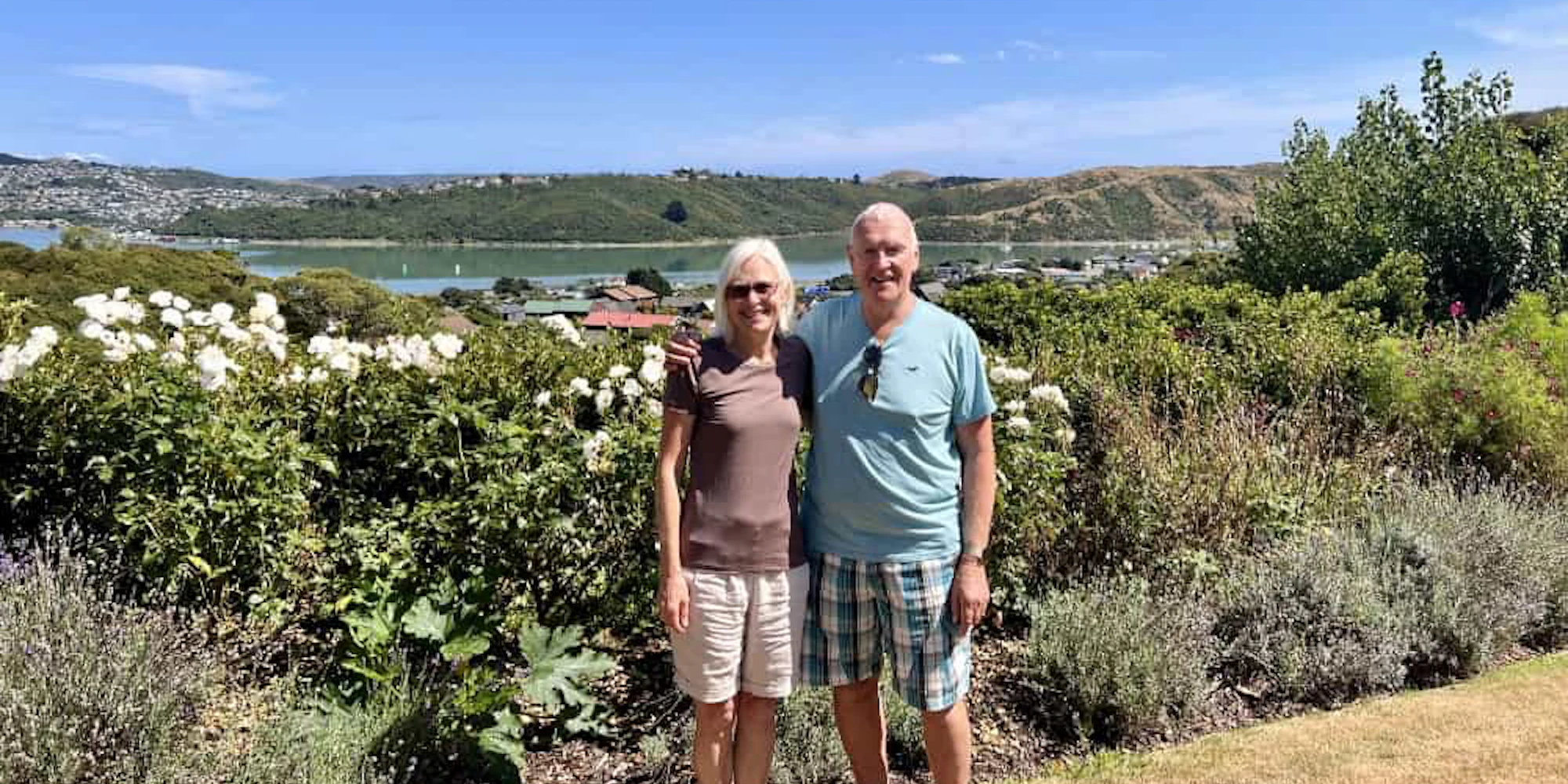 Carol and Leslie at Carol's garden with view of the bay