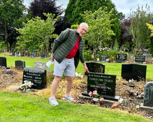 Leslie at his parent's grave.